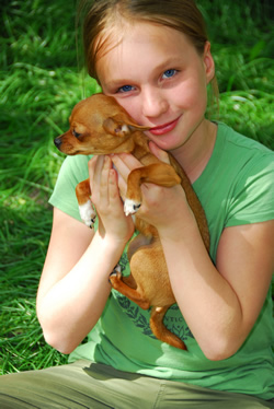 girl loving her puppy