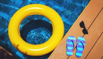 deck by pool with flipflops and float