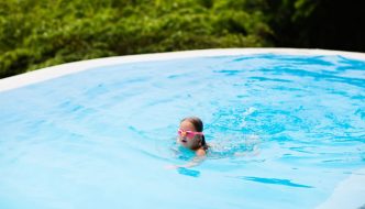 girl with goggles having fun in pool