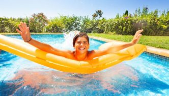 teen boy on raft in swimming pool