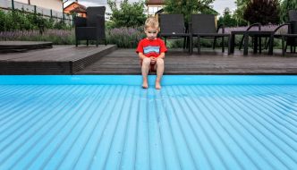 child with feet on pool cover