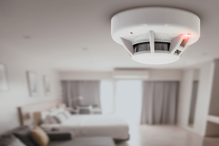 fire smoke detector attached to ceiling in living room