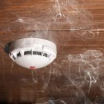 wisps of smoke around ceiling smoke detector