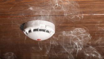 wisps of smoke around ceiling smoke detector
