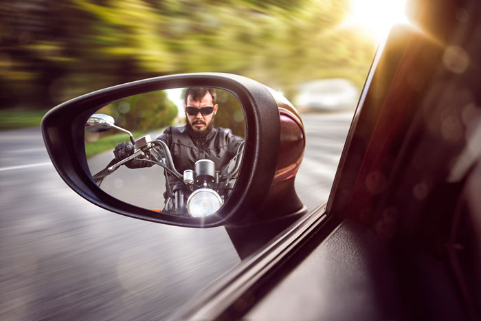 motorcyclist visible in drivers side mirror