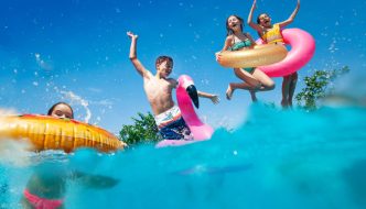 children having abundant fun with pool floats in water