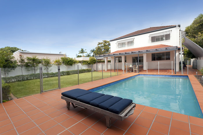 clear plexiglass fencing surrounding backyard pool