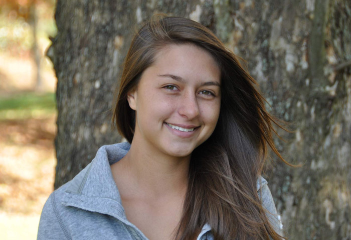 Young woman smiling and posing for senior portrait