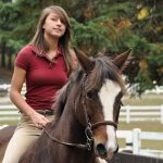 Young woman riding a horse